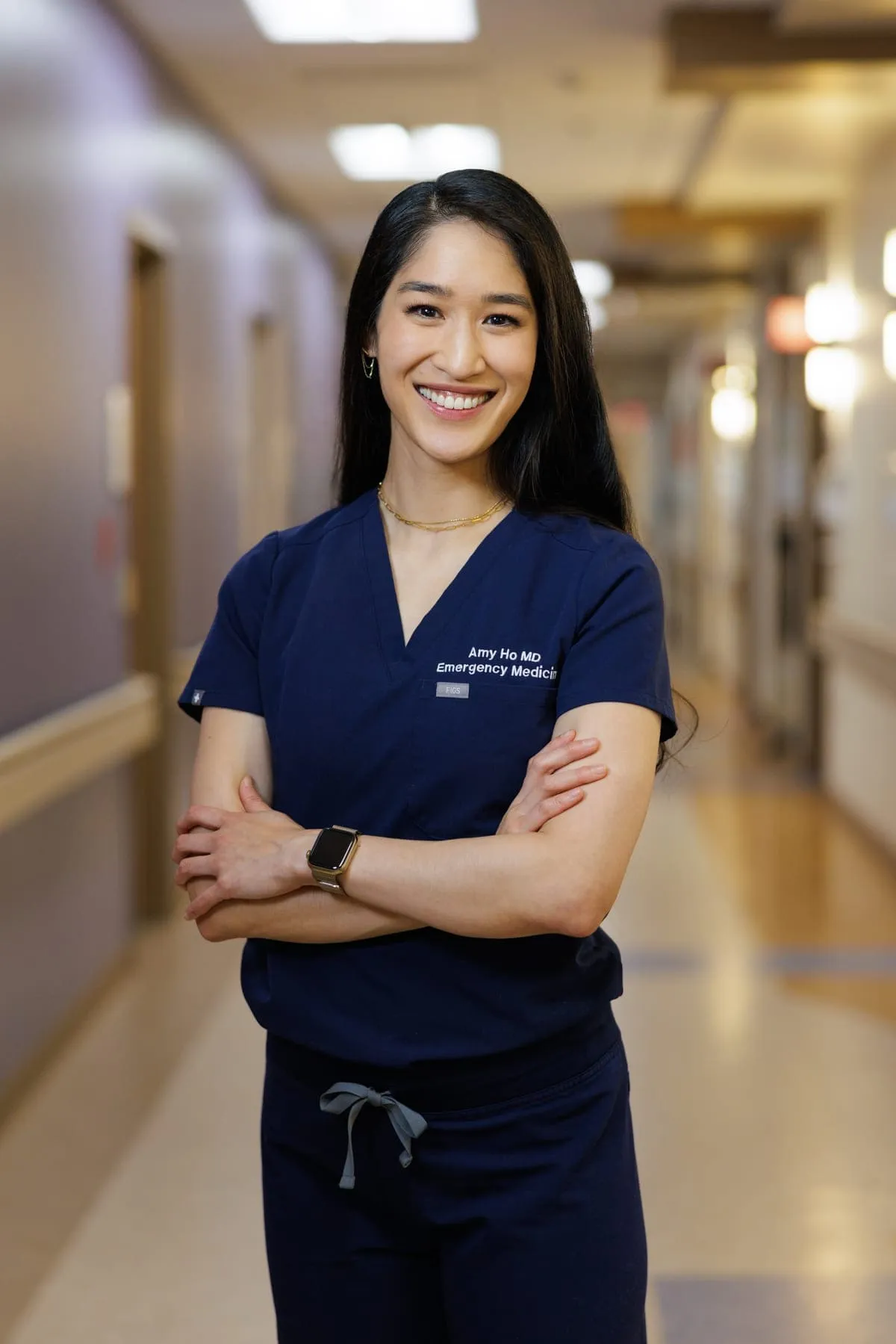Amy Faith Ho, MD, in scrubs in the emergency department corridor